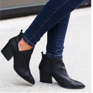 Black booties by Qupid